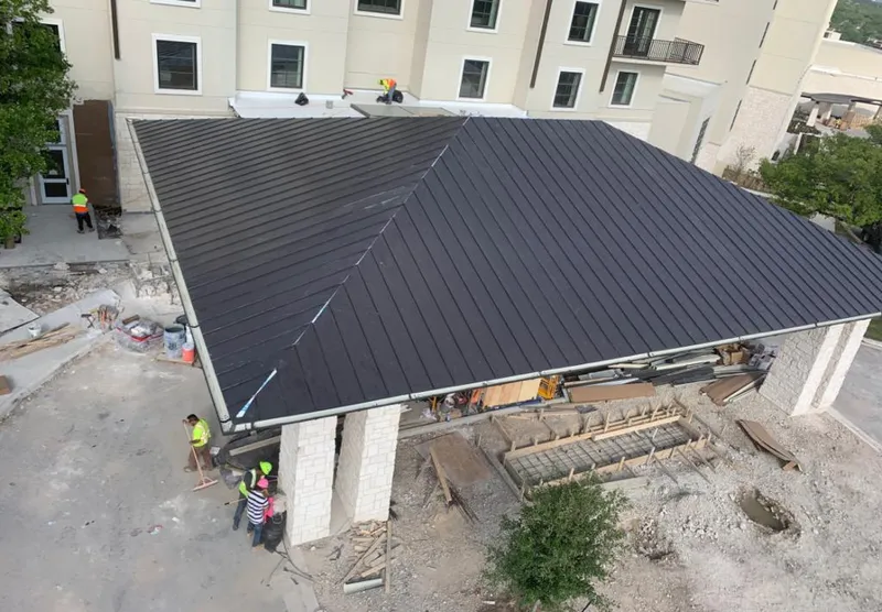 Metal roofing installation team working on a commercial building in Summit